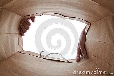 Hand opening brown paper bag Stock Photo