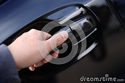 Hand opening a car door handle Stock Photo