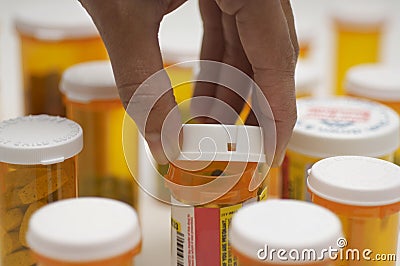 Hand Opening Pill Bottle Stock Photo