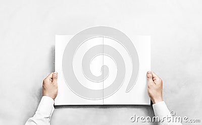 Hand opening white journal with blank pages mockup. Stock Photo