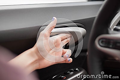 The hand opens the door inside the car. Close up Stock Photo