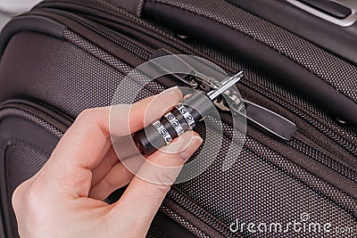 Hand opens suitcase combination lock Stock Photo
