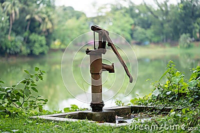 Hand operated water pump, rusted and forgotten Stock Photo