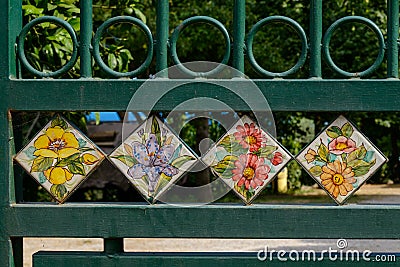 Hand painted tiles set up in street gate. Stock Photo