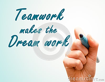 Hand with pen writing team work makes the dream work. Stock Photo