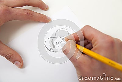 Hand with pencil writing love Stock Photo