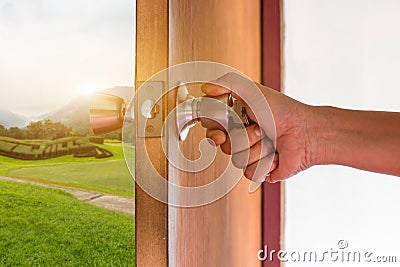 Hand of people open the door to inside ,outside door open putting into front door Stock Photo