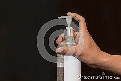 Hand of people are push pump bottle applying alcohol gel or anti bacteria soap to make hands cleaning and clear germ, bacteria, Stock Photo