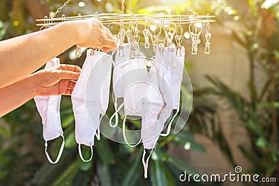 Hand of peple are hold many face masks are washed and dried for reuse anti bacteria and virus make to new face mask, bacteria, Stock Photo
