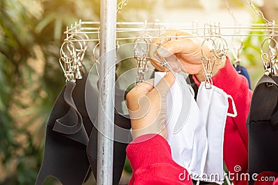 Hand of peple are hold many face masks are washed and dried for reuse anti bacteria and virus make to new face mask, bacteria, Stock Photo