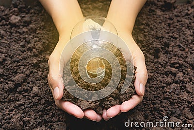 Hand of person holding light bulb with soil for idea, success Stock Photo