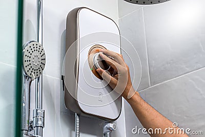 Hand person with water heater control panel Stock Photo