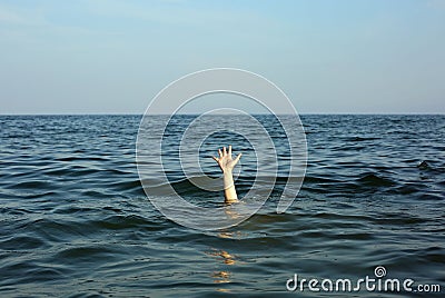 hand of the person who is about to drown in the middle of the se Stock Photo