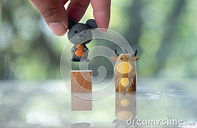 Hand pick up rat doll out with ox doll.The concept of change year from Year of the rat for Year of the ox Stock Photo