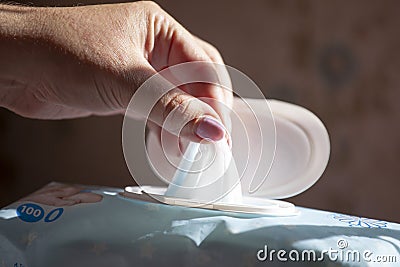 Wet wipes in a woman`s hand - Hand picked a wet wipes in package Stock Photo
