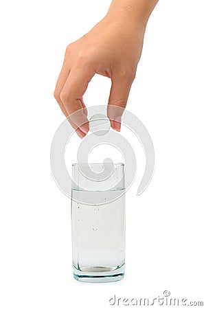 Hand with pill and water glass Stock Photo