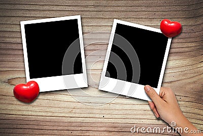 Hand placing Blank valentine photo frames Stock Photo