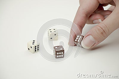 Hand placing dice on white background. Stock Photo