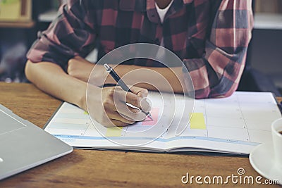 Hand of Planner write business agenda at Calendar, Meeting online at home. BusinessWoman plan daily appointment and note holiday Stock Photo