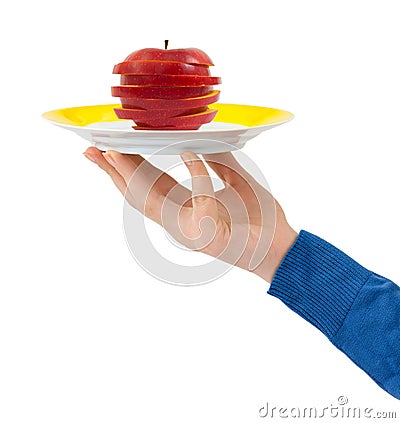 Hand with plate and chopped apple Stock Photo