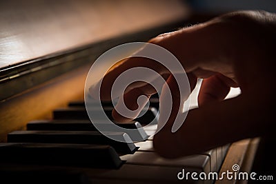 A hand playing piano Stock Photo