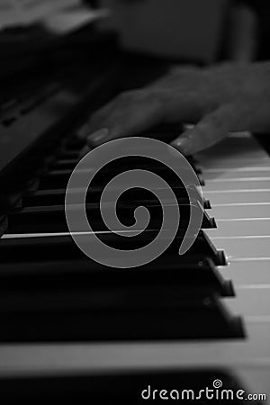 Hand playing piano perspective in black and white Stock Photo