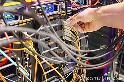 Hand Plugging Fiber Cable Into Switch In Datacenter Stock Photo