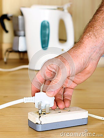 Plugging in a power cord to a Dangerous Broken SocketPower Cords in a Dangerouse Tangled Mess Stock Photo