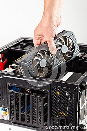 Hand plugging a video card while maintenance personal computer hardware with selective focus Stock Photo