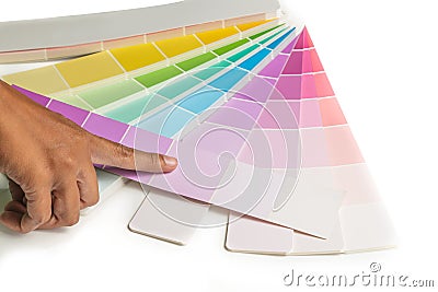 A hand point to colored swatches for choose paint sample on the white background Stock Photo