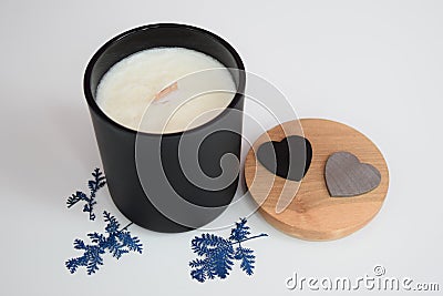 Hand-poured scented soy candle in black aura vessel. Stock Photo