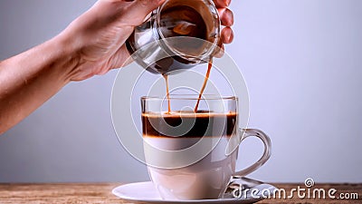 Hand pouring chocolate drink in a glass Stock Photo