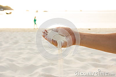 Hand pours sand Stock Photo