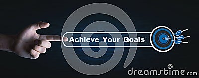 Hand press Achieve Your Goals text with a target dart Stock Photo