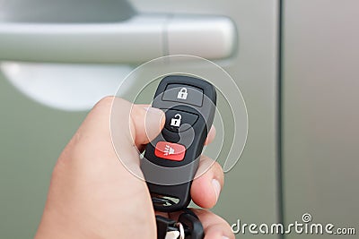 Hand presses on the remote control car alarm Stock Photo