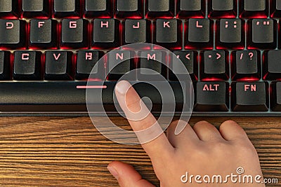 Hand presses the space bar Stock Photo