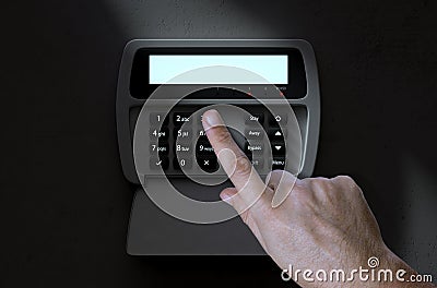 Hand Pressing Home Security System Stock Photo