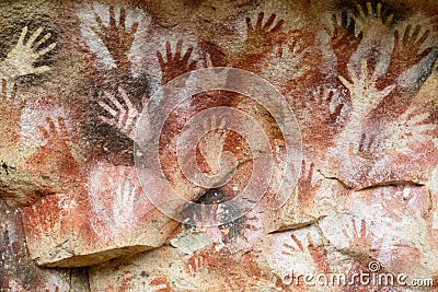 Hand prints on a cave wall Stock Photo