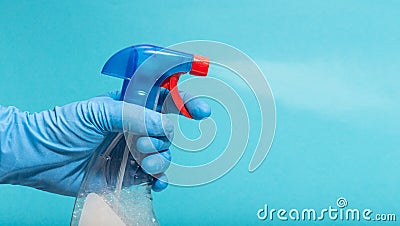 Hand in protective glove spraying disinfectant Stock Photo
