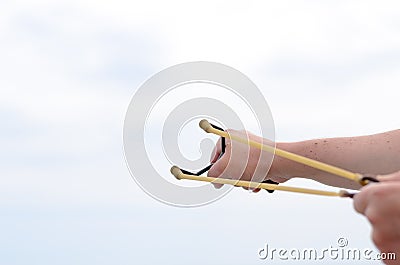 Hand Pulling Bands of his Stone Shooter Stick Stock Photo
