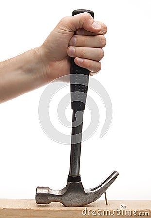 Hand pulling out a nail with hammer Stock Photo
