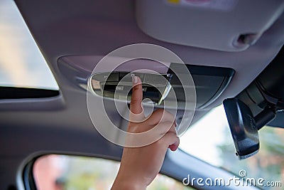 hand push button on ceiling console and open panoramic roof window in modern car Stock Photo