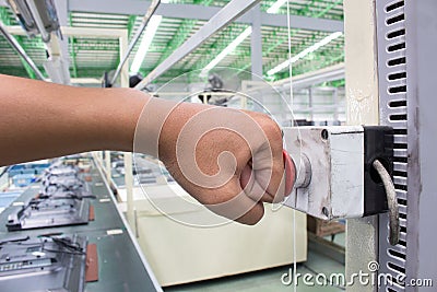 Hand push Emergency button in product line Stock Photo