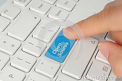 Hand pushing blue open source keyboard button Stock Photo
