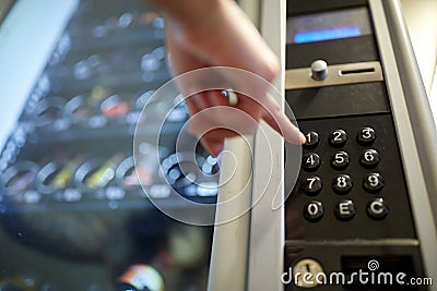 Hand pushing button on vending machine keyboard Stock Photo