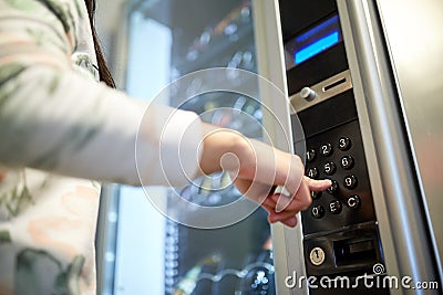 Hand pushing button on vending machine keyboard Stock Photo