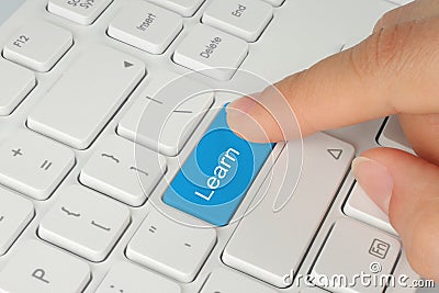 Hand pushing learn button Stock Photo