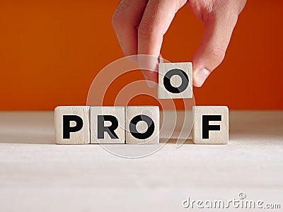 Hand puts the wooden cube with the word proof. To find a proof, evidence, verifying or proving something Stock Photo