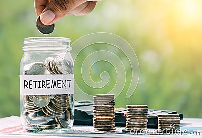 Hand putting money for retirement money for the future. Stock Photo