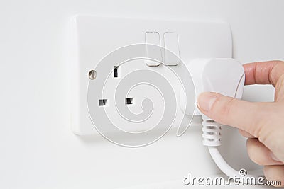 Hand Putting Plug Into Electricity Socket Stock Photo